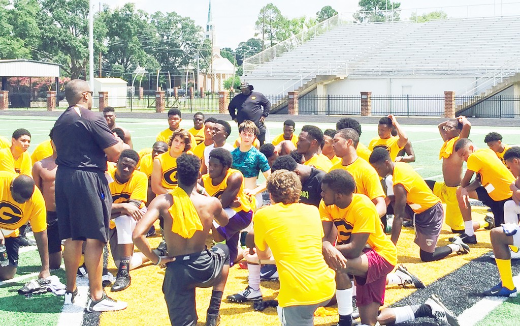 RICKY JACKSON/Courtesy photo Head football coach Broderick Fobbs talks to campers who attended the Monroe summer camp in June.