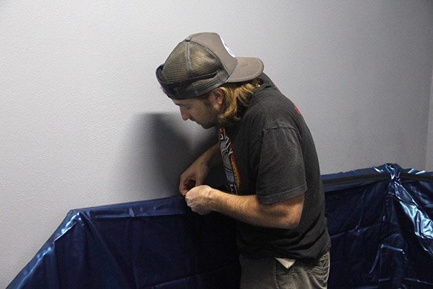 Ryan Helg, owner of Levitate float center, sets up the inner lining of a tank.